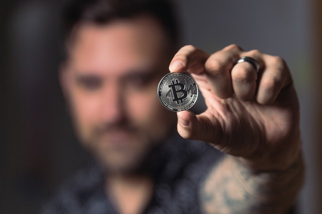 A man holding a bitcoin cryptocurrency