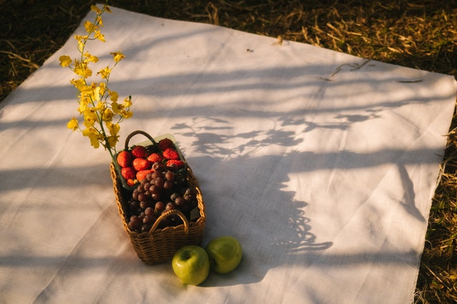A picnic blanket and basket products from an online store.